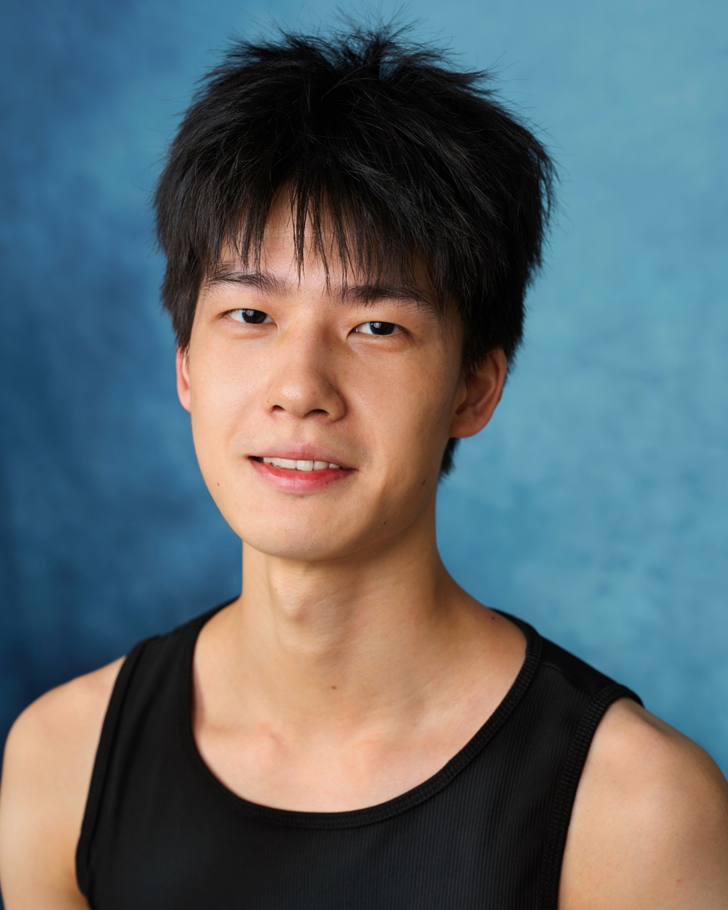 Fred Sheng, actor headshot in a black vest